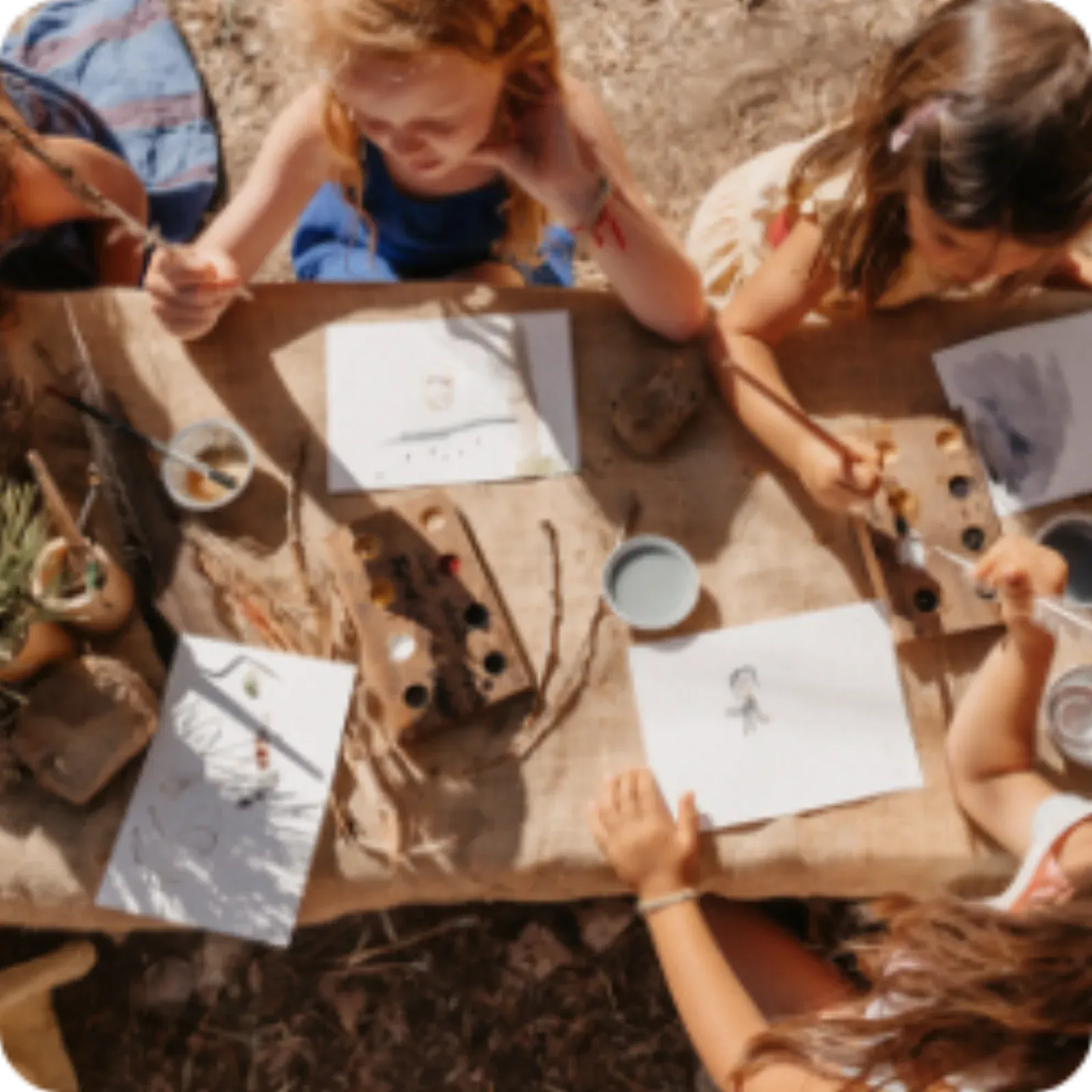 Children drawing together at a table, seen from above