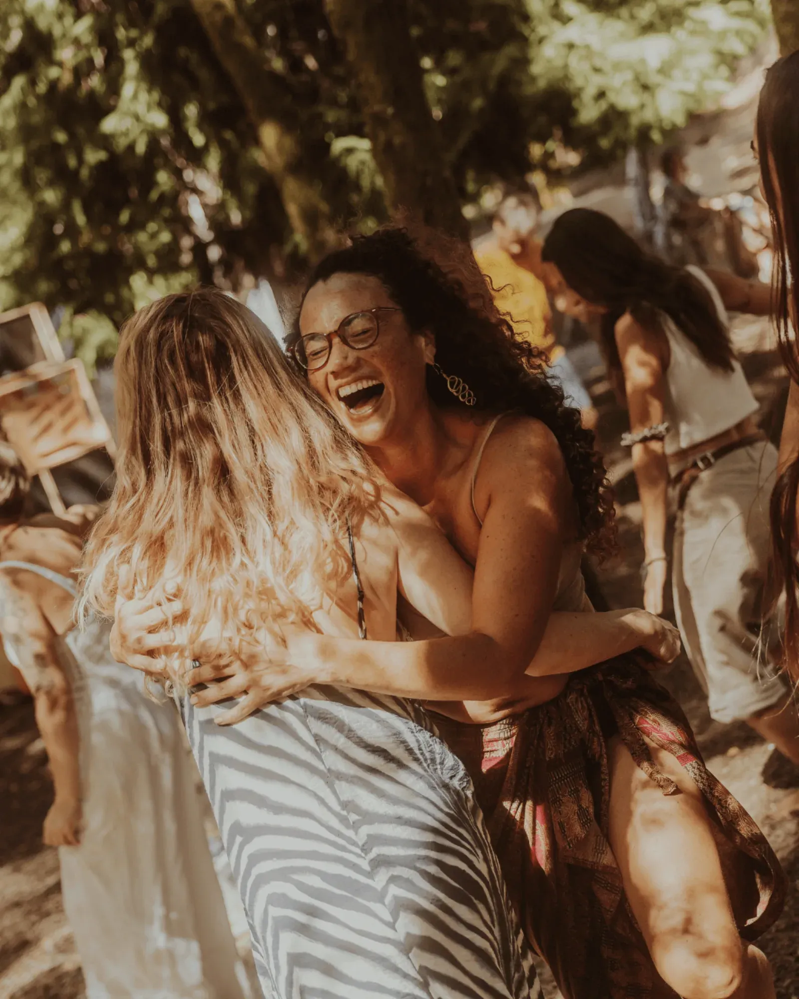 Two women laughing in a hug