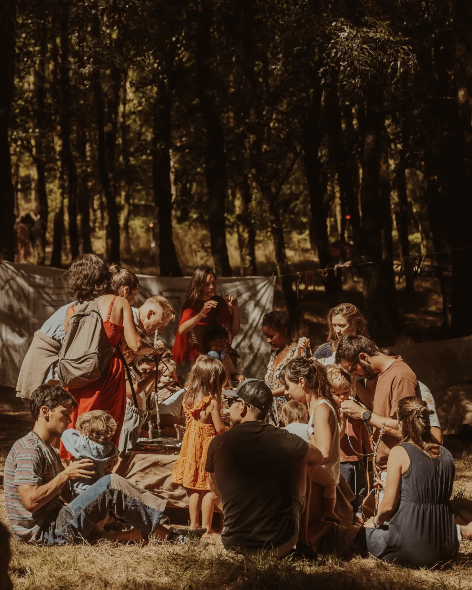 A circle of people sitting together in the forest
