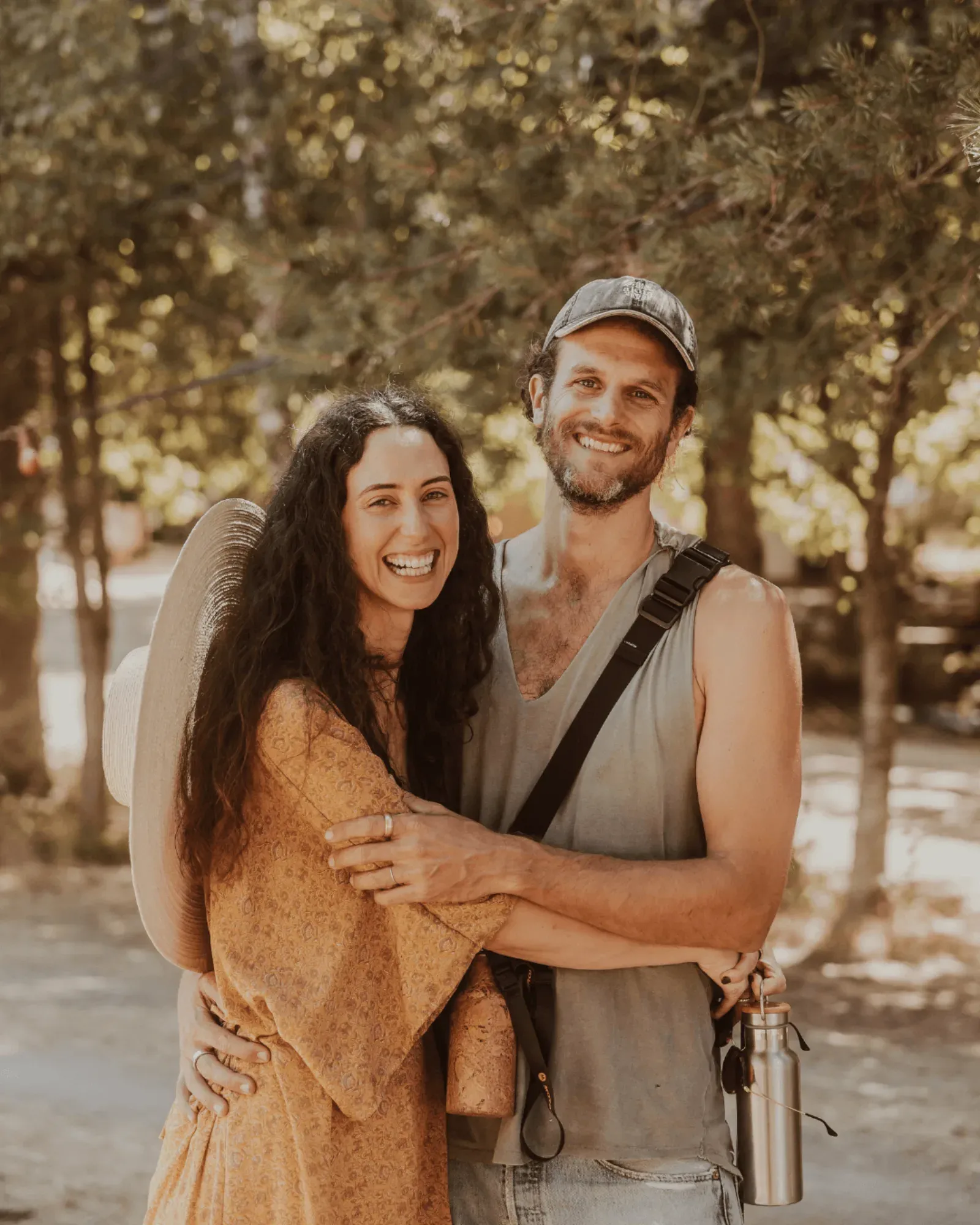 A couple embracing and smiling in the forest